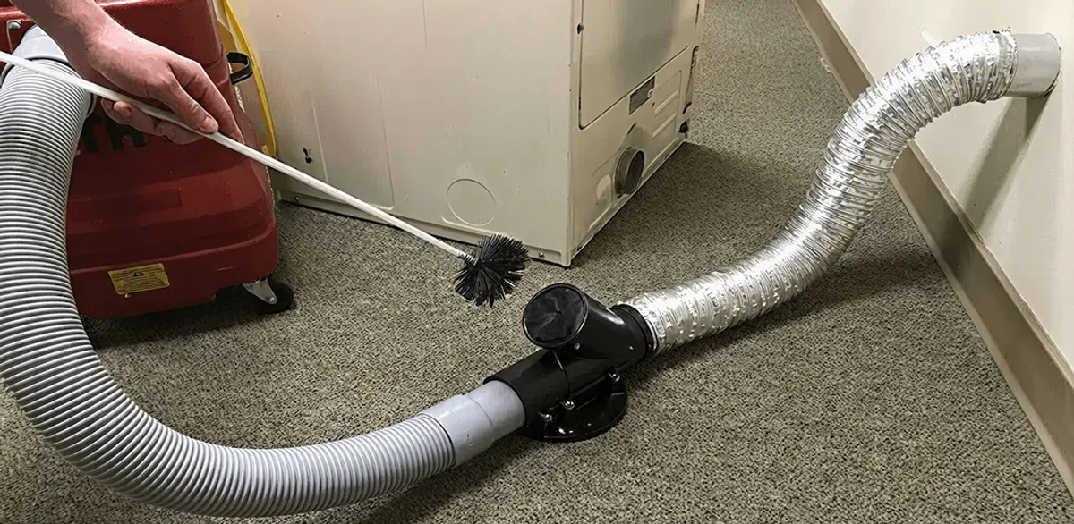 Dryer vent cleaning service removing lint from a dryer duct connection in Riverside, CA