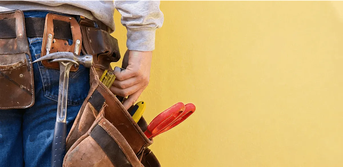 Handyman with tool belt ready for home repairs and maintenance in Riverside, CA