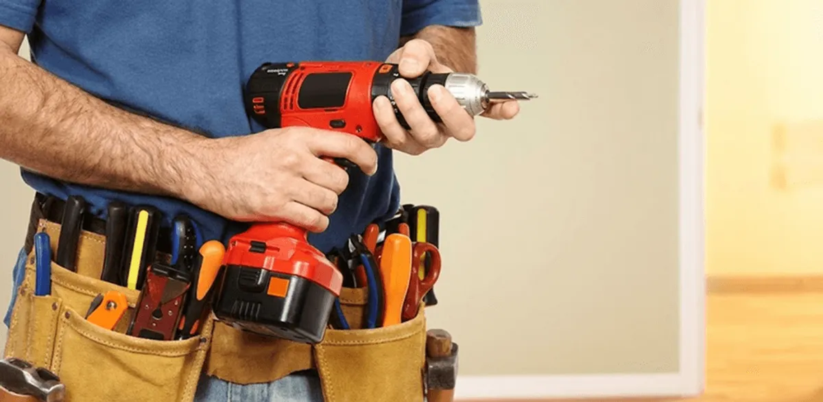 Handyman holding a power drill for home repairs and installations in Riverside, CA